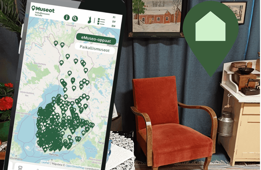 karttanäkymä puhelimen näytöllä ja taustalla nojatuoli sekä taulu